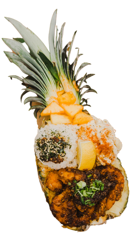 A hollowed out half of a pineapple, filled with food